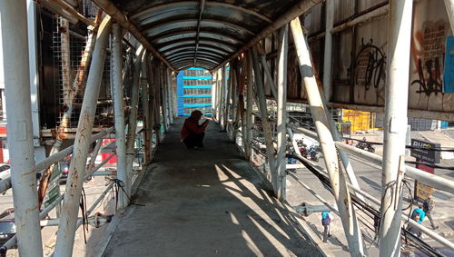 Rear view of people walking on street amidst buildings