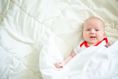 High angle view of cute baby sleeping on bed