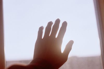 Close-up of hand against clear sky