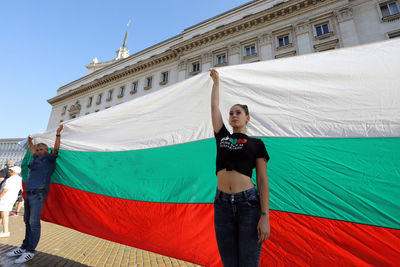 Portrait of beautiful young woman against blue sky