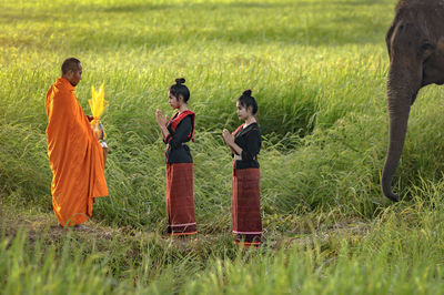 Boys standing on grassy field