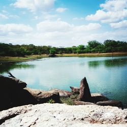 Scenic view of lake against cloudy sky