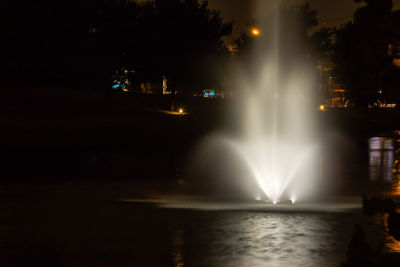 Illuminated fountain at night