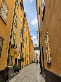 People walking on street amidst buildings in city