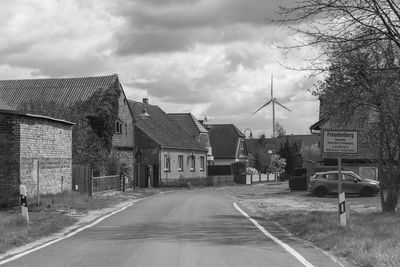 Road amidst buildings against sky in city