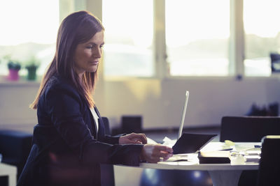 Businesswoman reading document in office