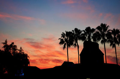 Low angle view of silhouette trees against sky at sunset