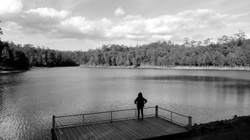 Rear view of woman by lake 