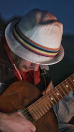 Close-up of man playing guitar