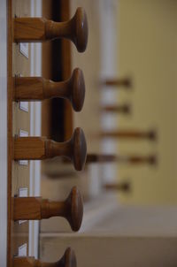 Close-up of wooden rack on wall