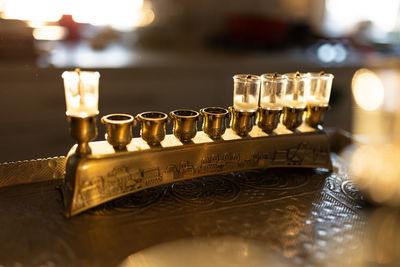 Close-up of illuminated candles on table