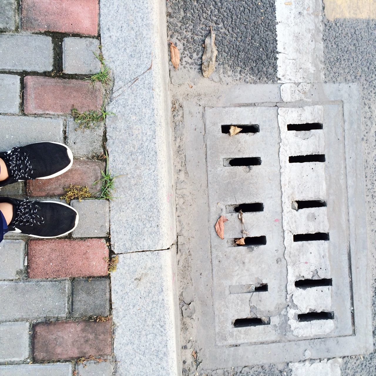 building exterior, built structure, architecture, brick wall, day, outdoors, wall - building feature, street, shoe, sidewalk, part of, pattern, cobblestone, wall, high angle view, close-up, sunlight, window