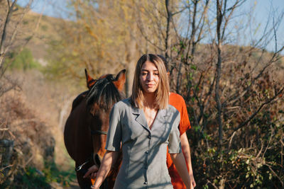 Women with horse in forest