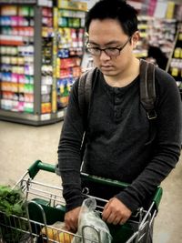 Mid adult man sitting in store