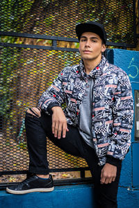 Portrait of young man sitting on seat