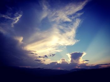 Low angle view of dramatic sky over landscape