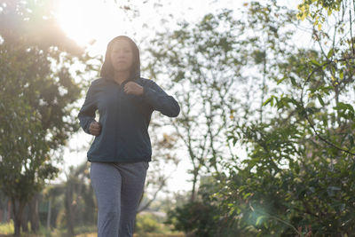 Portrait of woman running in park