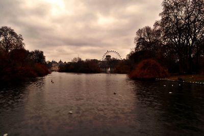 Scenic view of river against cloudy sky