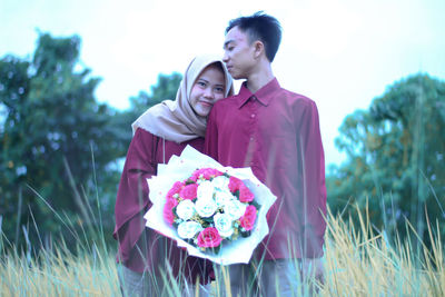 Young couple kissing on field