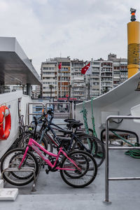 Bicycles parked on street against buildings in city