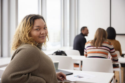 Portrait of smiling woman in class