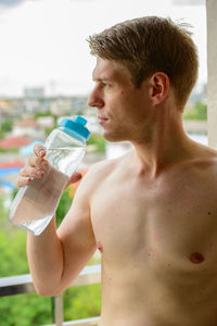 Young man drinking water from bottle