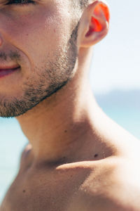 Close-up portrait of shirtless young man