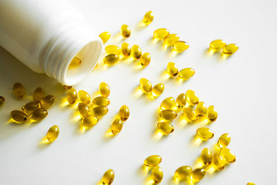 High angle view of pills on white background