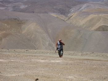 Rear view of man walking on mountain