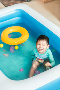 High angle view of cute boy swimming in pool