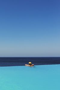 View of swimming pool in sea against clear sky