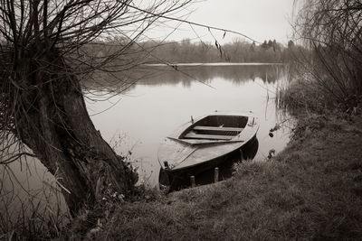 Boats moored at lakeshore