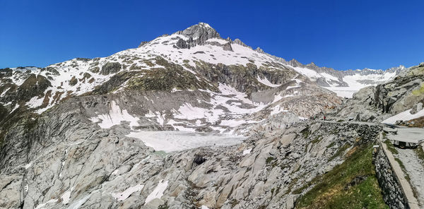 Scenic view of snowcapped mountains against clear sky