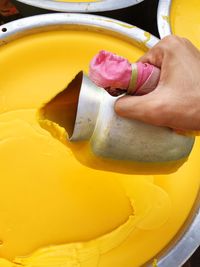 Cropped image of man pouring jug in beeswax at market