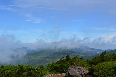 Scenic view of mountains against cloudy sky