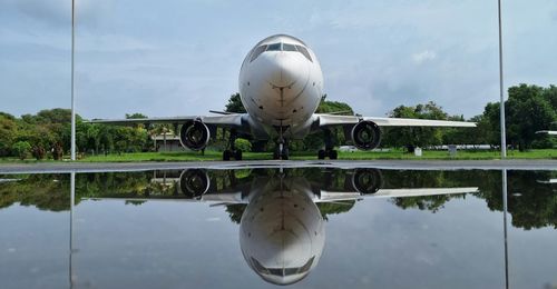 Reflection of airplane in lake