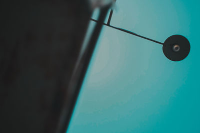 Low angle view of electric lamp on wall