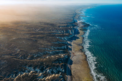 High angle view of sea shore against sky