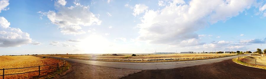 Panoramic view of empty road against sky