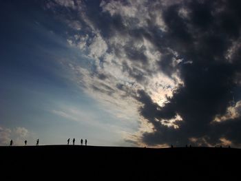 Silhouette landscape against sky at sunset