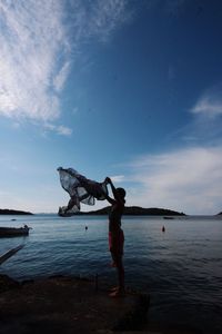 Full length of woman on beach against sky