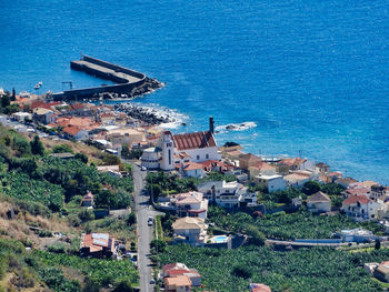 High angle view of townscape by sea