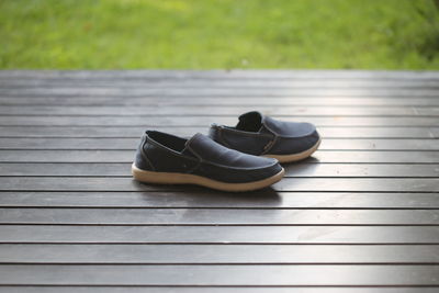 High angle view of shoes on boardwalk