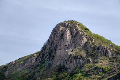 Low angle view of rock formation against sky