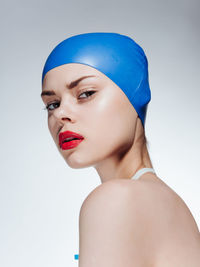 Close-up of young woman against white background