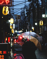 Illuminated street lights in city at night