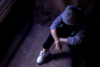 High angle view of man sitting in abandoned room