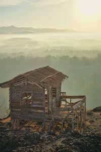 Abandoned house on field against sky