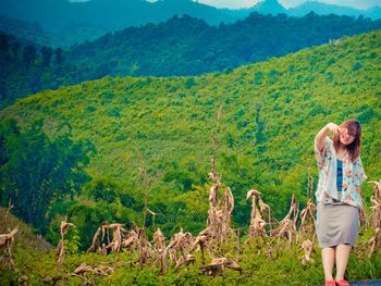 Full length of a woman standing on landscape