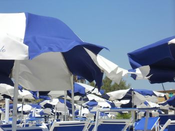 Low angle view of flags against blue sky